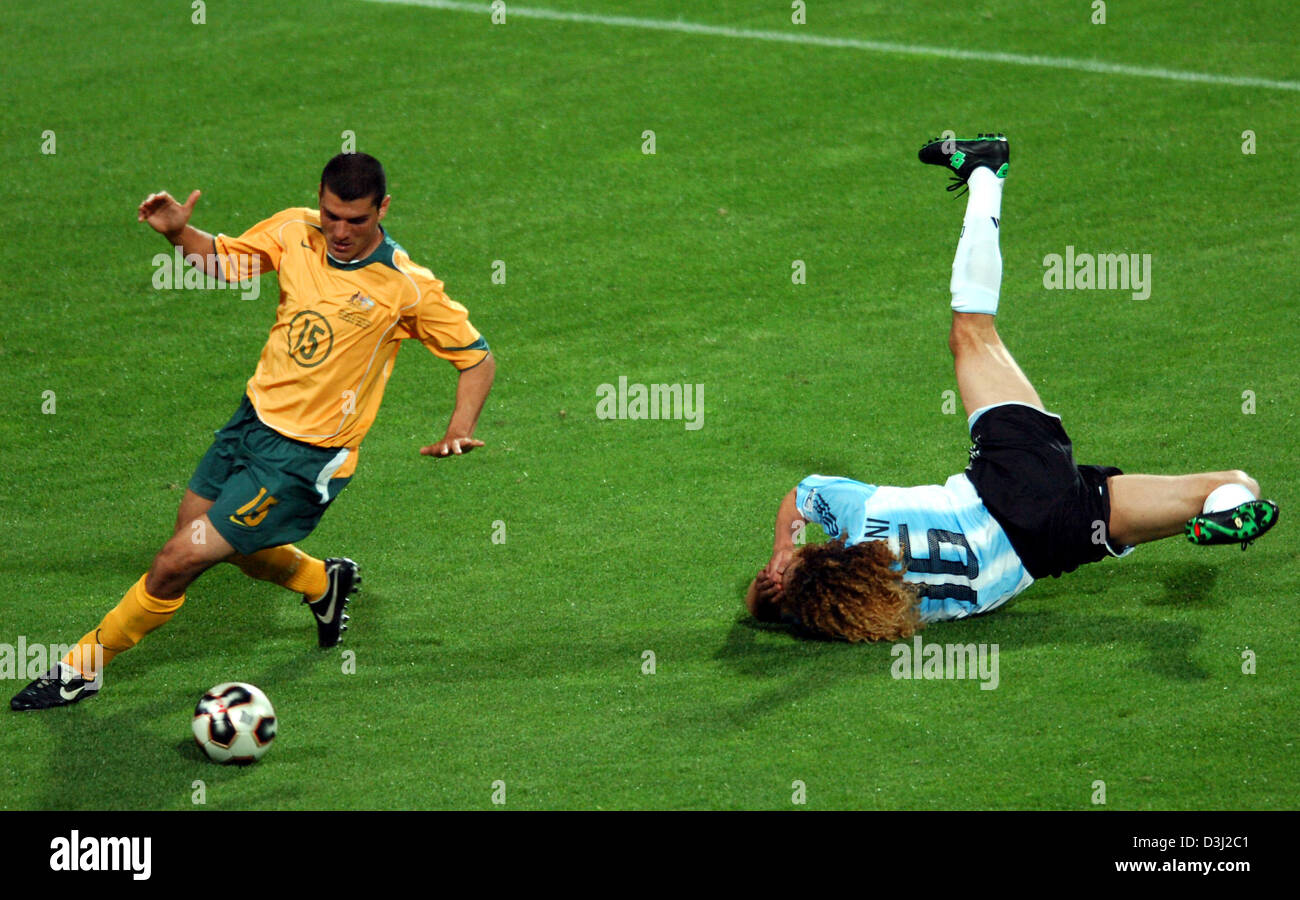 (Dpa) - calcio argentino player Fabricio Coloccini (R) cade al suolo dopo aver perso la lotta per la palla contro il giocatore australiano John Aloisi durante il gruppo a una partita della Confederations Cup Australia vs Argentina al Franken-Stadium in Nuremberg, Germania, 18 giugno 2005. Foto Stock
