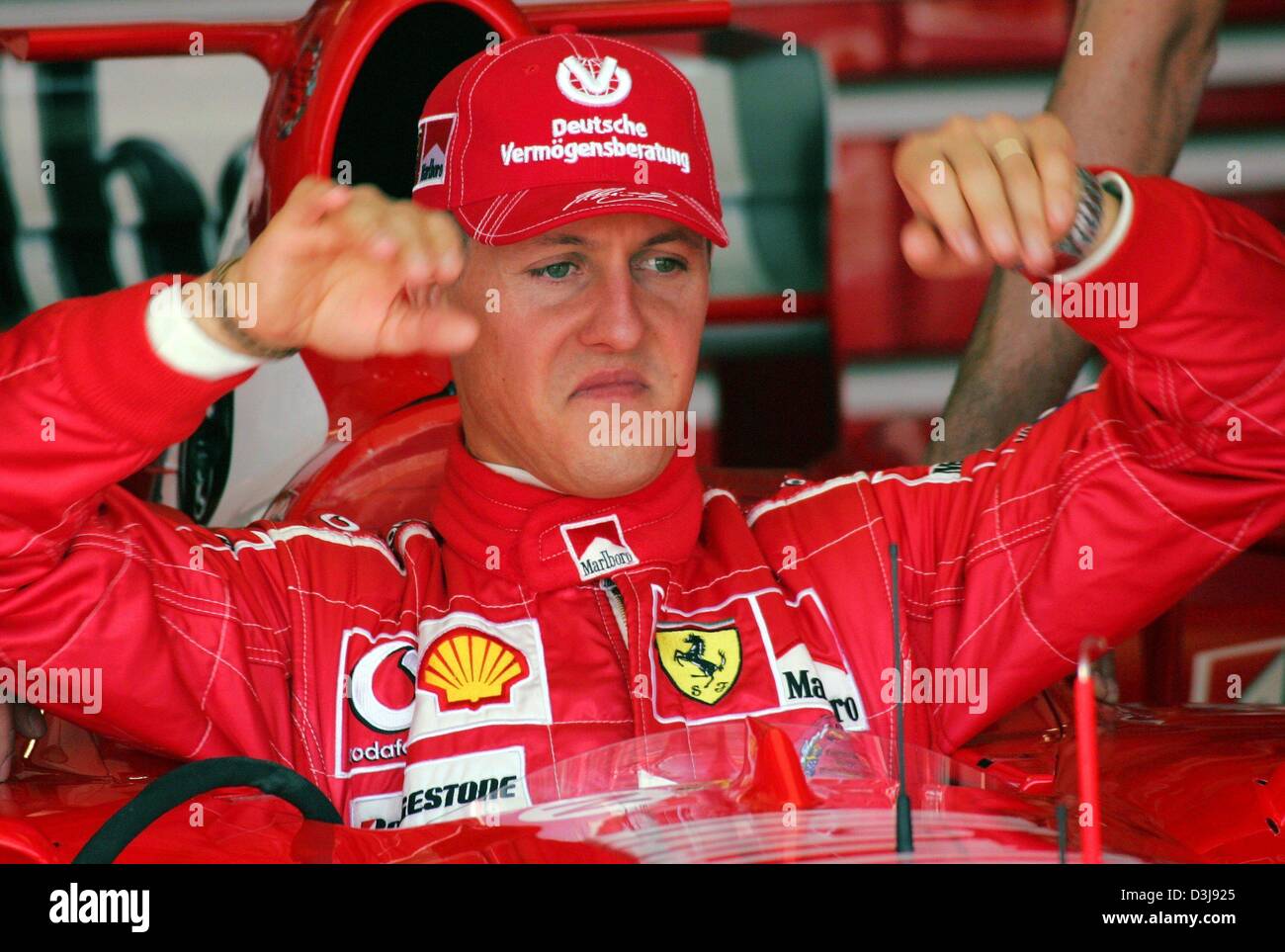(Dpa) - tedesco di Formula Uno del campione del mondo in carica Michael Schumacher (Ferrari) esce dalla sua vettura da corsa dopo il corso di formazione gratuito presso la "Enzo e Dino Ferrari di Formula Uno circuito di gara di Imola, Italia, 23 aprile 2004. Il gran premio di San Marino inizia domenica 25 aprile 2004. Foto Stock