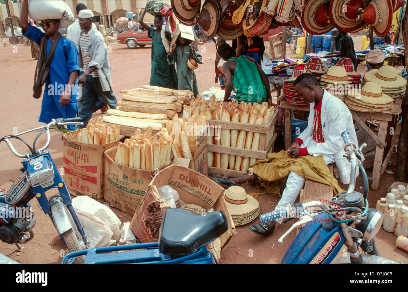 I commercianti di strada che vendono baguette francesi di stile e cappelli tradizionali, Mopti. Mali. Africa occidentale Foto Stock