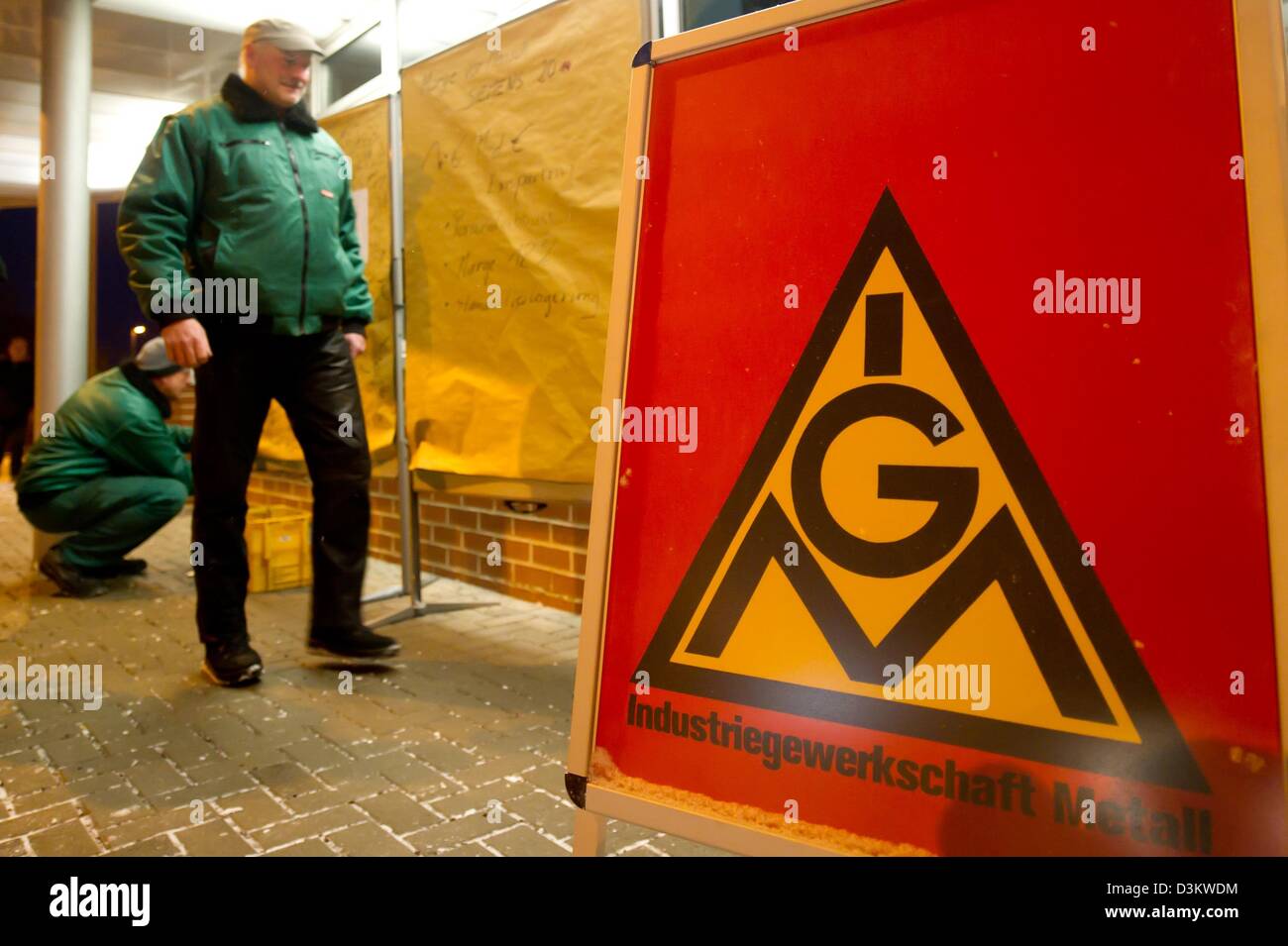 Un dipendente Siemens passeggiate passato una targhetta di protesta presso l'impianto di Siemens a Erfurt, Germania, 21 febbraio 2013. I dipendenti Siemens ha annunciato le azioni di protesta contro le previste misure di austerità in tutta la Germania. Foto: Marc Tirl Foto Stock