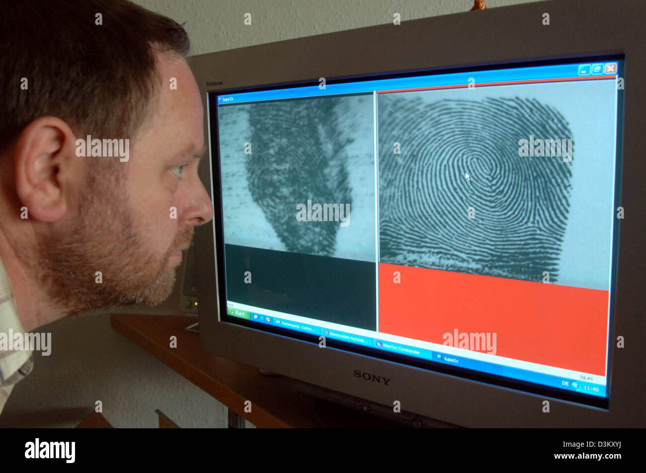 (Dpa) - Esperto per dactyloscopy identificazione e Michael Fischer del crimine di Stato Office confronta le impronte digitali sullo schermo di un computer a Magdeburgo, in Germania, mercoledì 28 settembre 2005. Il classico di identificazione di impronte digitali rimane essenziale nell'investigazione di reati nonostante i progressi nel DNA-analisi. Quasi tre milioni di impronte digitali sono già memorizzati nel database di tedesco. Pres Foto Stock