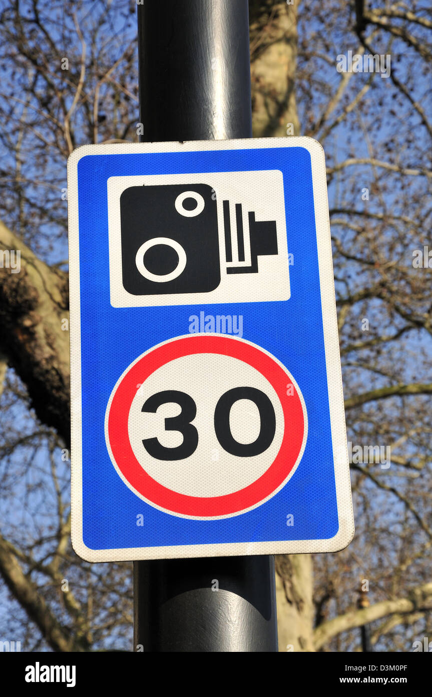 Londra, Inghilterra, Regno Unito. Un cartello stradale - 30 miglia per ora limitare / autovelox in azione Foto Stock