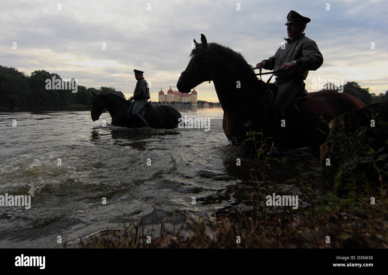 Moritzburg, Germania, silhouette di cavalli e cavalieri nel lago di fronte alla Schloss Moritzburg Foto Stock