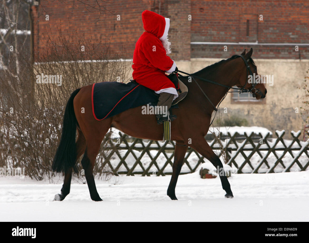 Hoppegarten, Germania, a Santa Claus in sella a un cavallo attraverso la neve Foto Stock