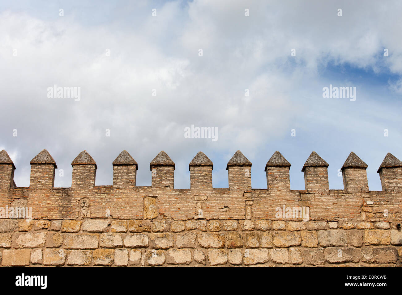 Mura fortificate del real Alcazar di Siviglia, Spagna, fatta di mattoni e pietra. Foto Stock