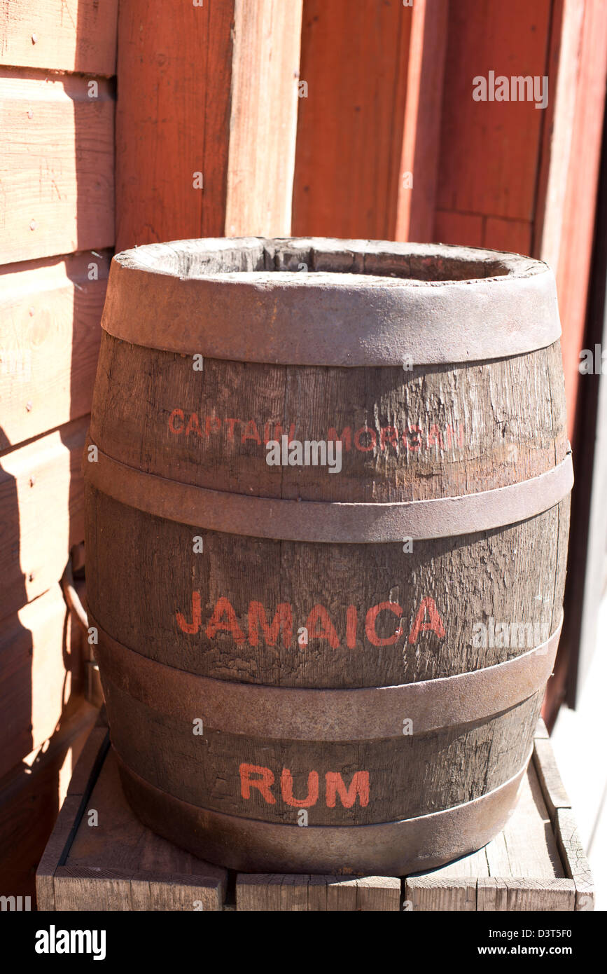 Barile di rum giamaicano davanti un rosso casa in legno Foto Stock