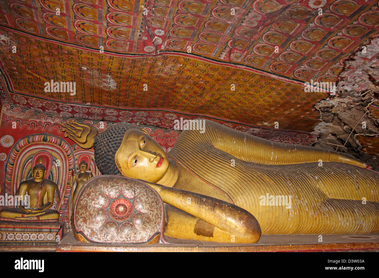 Il Buddha reclinato Al Maha Alut Viharaya tempio nella grotta Foto Stock