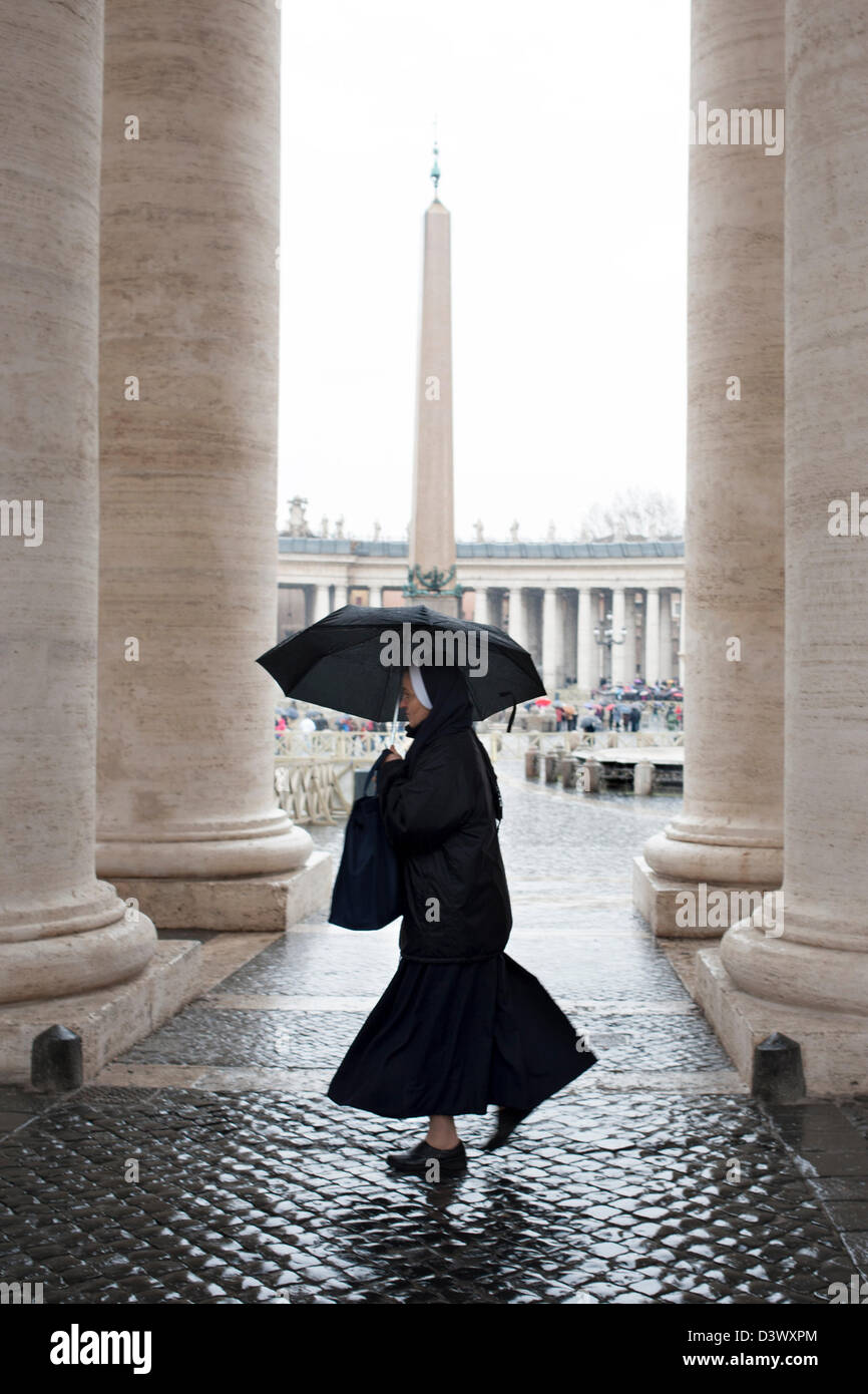 Nun con ombrellone in San Pietro colonnato Foto Stock