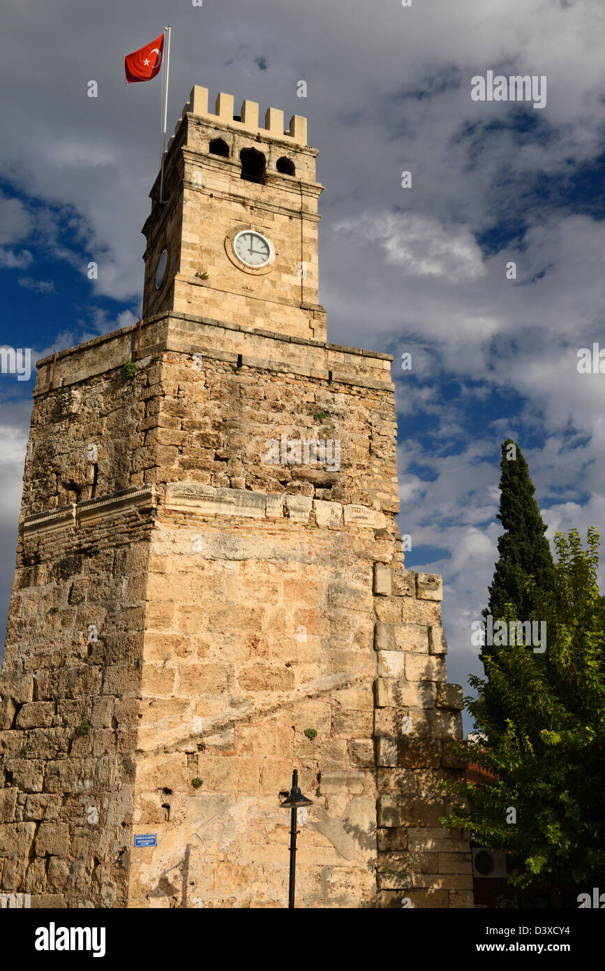 Saat Kulesi Clock Tower con bandiera turca sul muro romano in castello area di gate di Antalya, Turchia Foto Stock