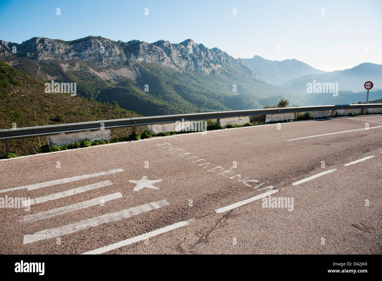 La parola "Independencia" - Indipendenza e una simboleggiato Valencian o bandiera catalana sono dipinti su strada in Spagna Foto Stock