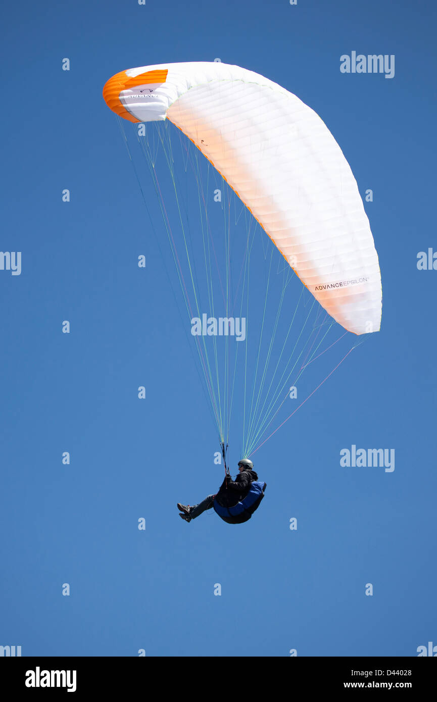 Parapendio maschio gode di un volo in un cielo blu in Ager, Lleida, in Catalogna, Spagna. Foto Stock