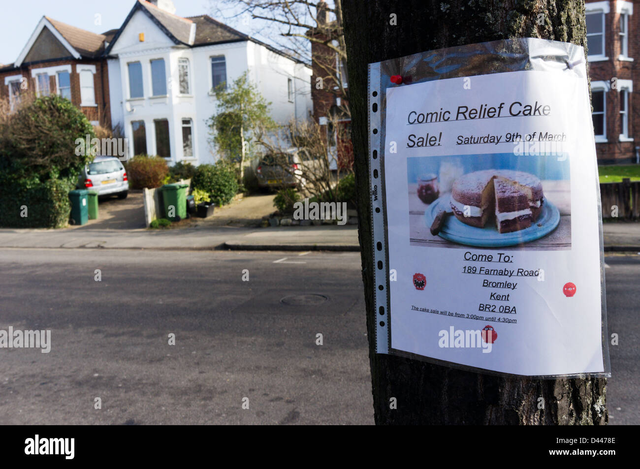 Un segno imperniato ad un albero in una strada suburbana annuncia una vendita di torte in aiuto del comico sollievo Foto Stock