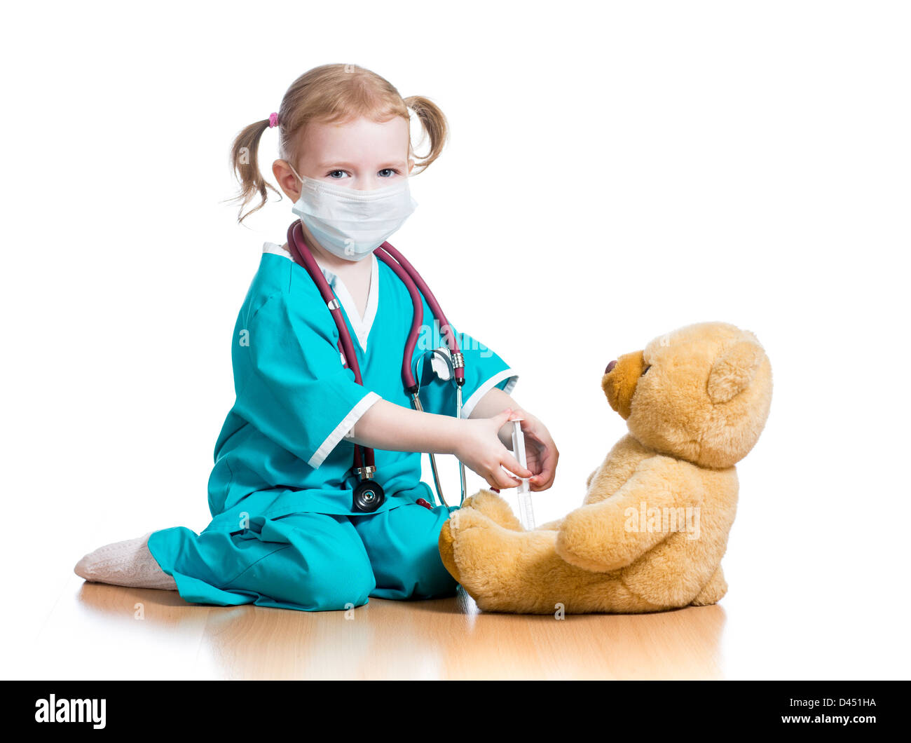 Bambino ragazza con vestiti di dottore giocare con toy Foto Stock