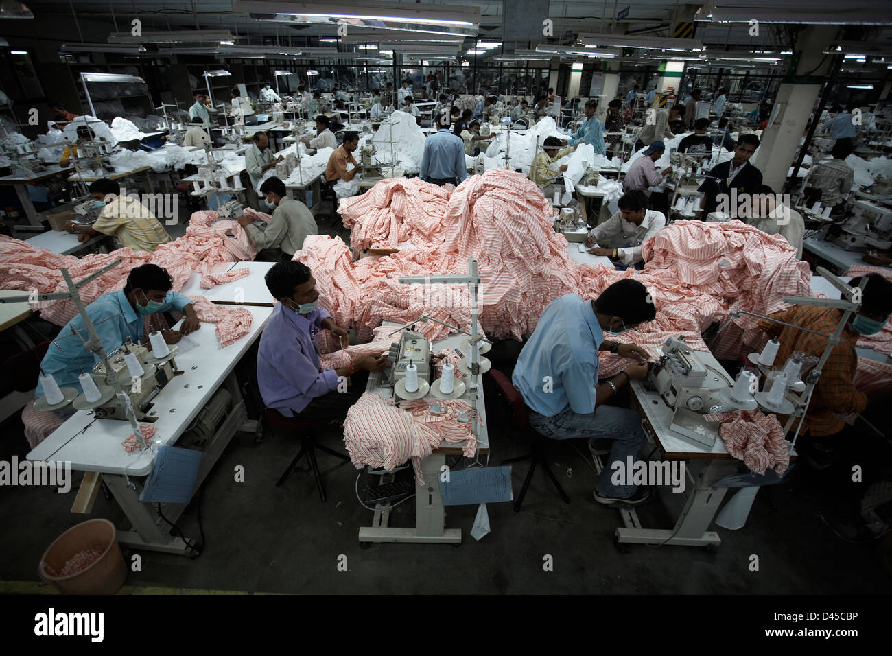 Lavoratori indiani cucire vestiti in fabbrica. Foto Stock