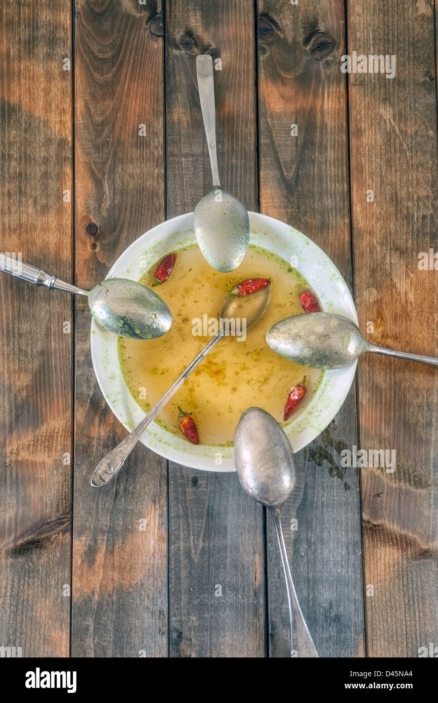 Piastra di zuppa con peperoncini piccanti e cinque cucchiai Foto Stock