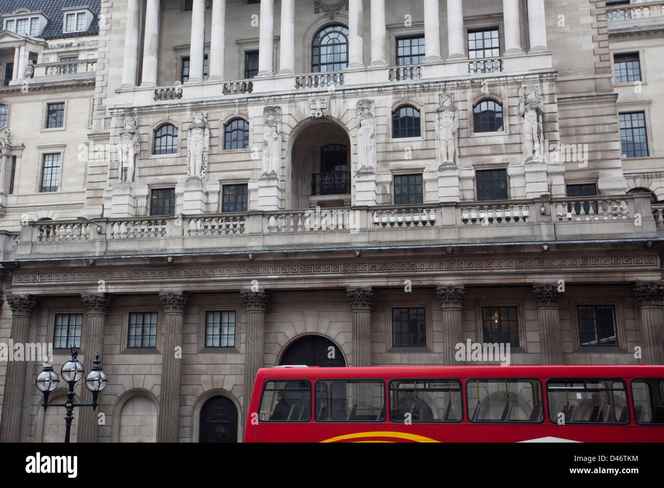 Tradizionale bus rosso a due piani con architettura di Londra in background. Foto Stock