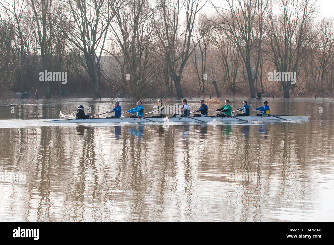 Il canottaggio otto su un allenamento invernale gita sul lago di Peterborough durante le inondazioni Foto Stock