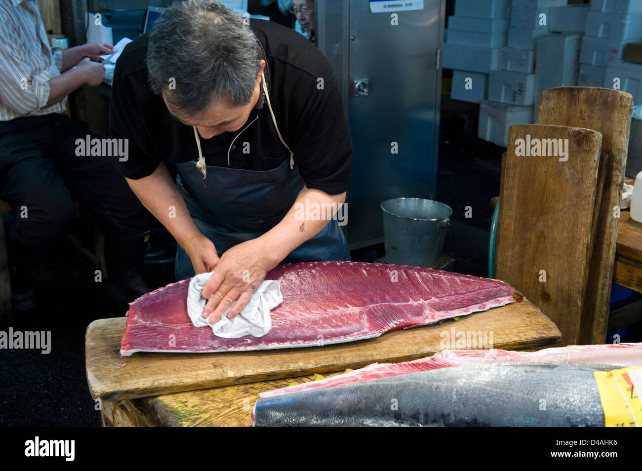 Un pescivendolo mette il tocco finale a una grande lastra di fresco tagliare il tonno a Tsukiji Commercio all'ingrosso Mercato del Pesce di Tokyo Foto Stock