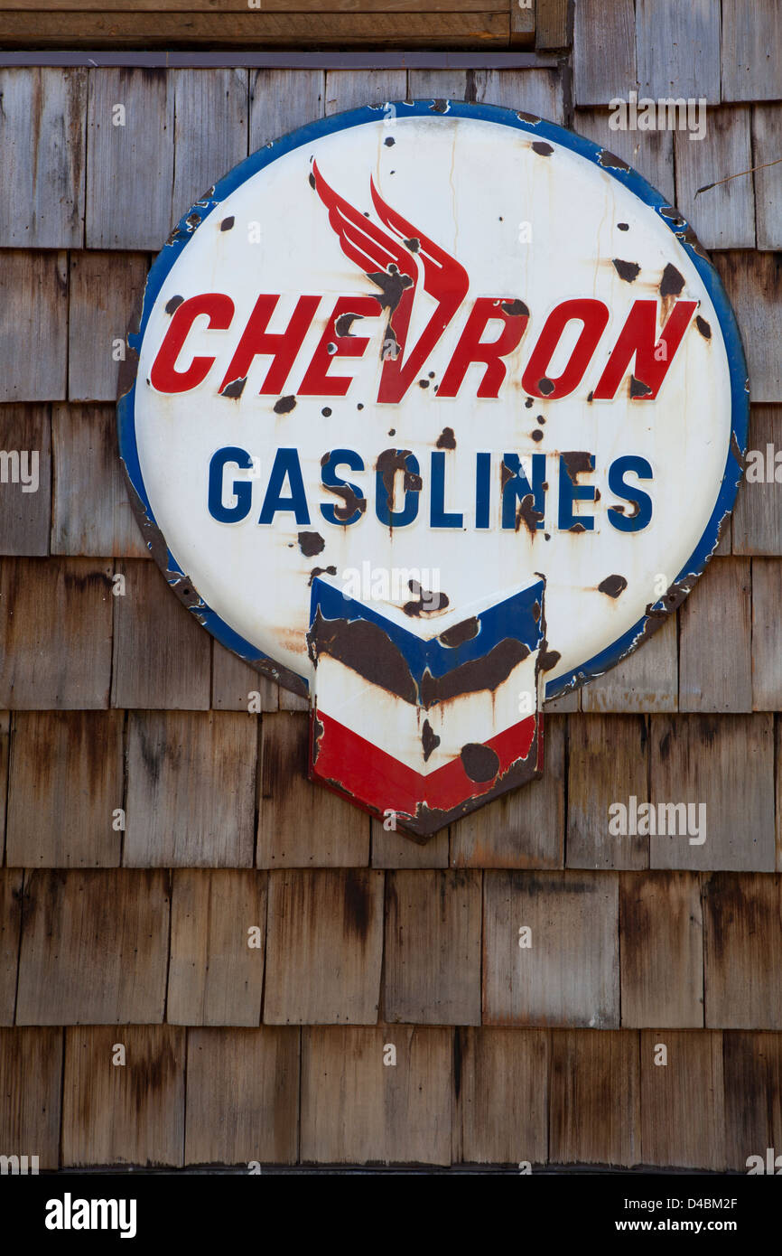 Un vecchio arrugginito benzine Chevron segno su una parete in Ashford, Washington, Stati Uniti d'America Foto Stock