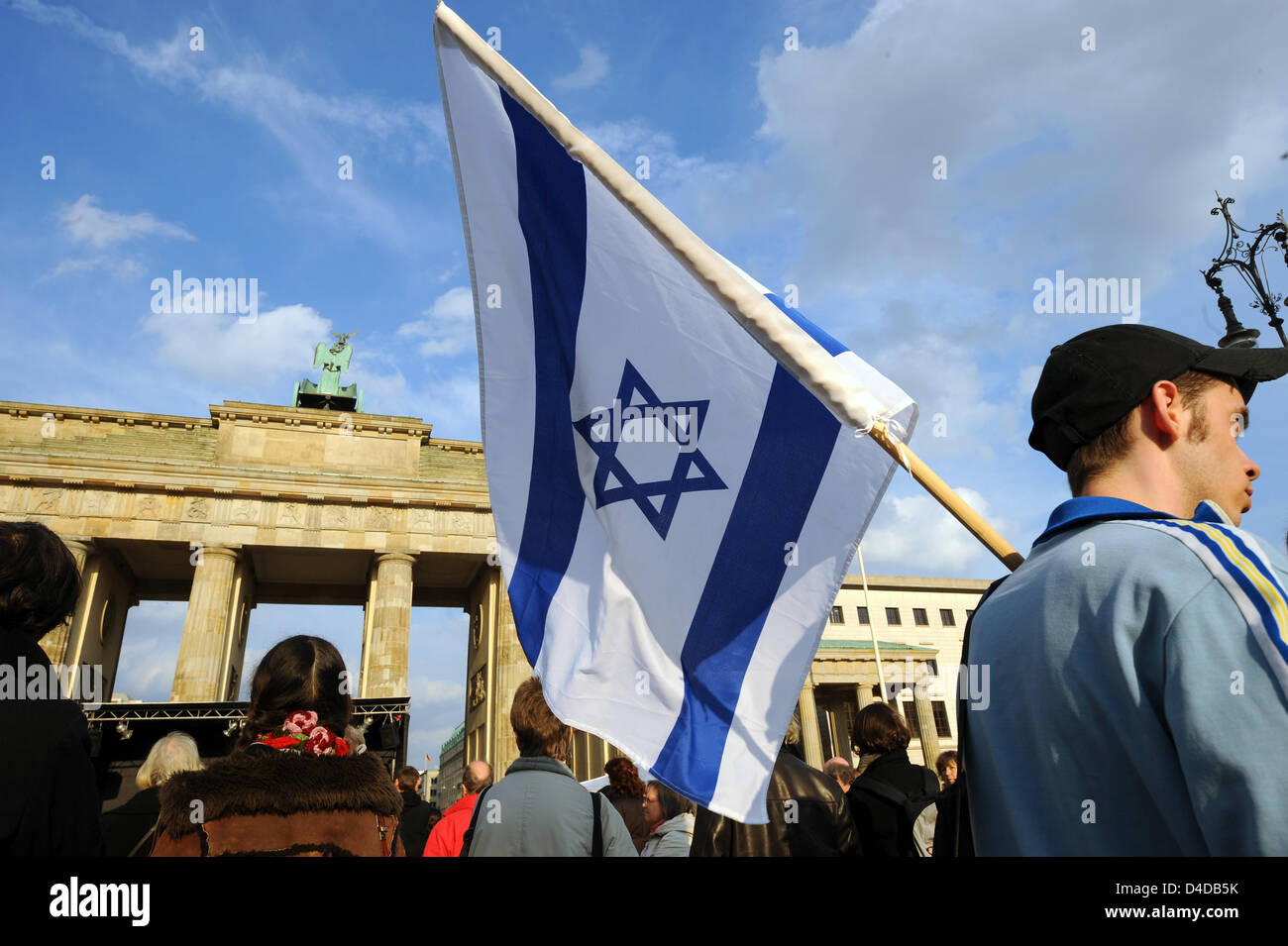 Un uomo con una bandiera israeliana si erge di fronte alla Porta di Brandeburgo a Berlino, Germania, 12 aprile 2008. 4646 candele sono in procinto di essere acceso dopo una passeggiata silenziosa per le ferrovie tedesche il quartier generale a commemorare berlinese di vittime di Nazi-Germany. La Reichsbahn trasportati circa 3 milioni di persone nei campi di concentramento e di sterminio. Foto: Gero Breloer Foto Stock
