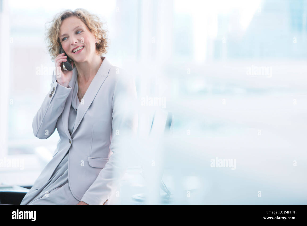 Imprenditrice parlando al telefono in ufficio Foto Stock