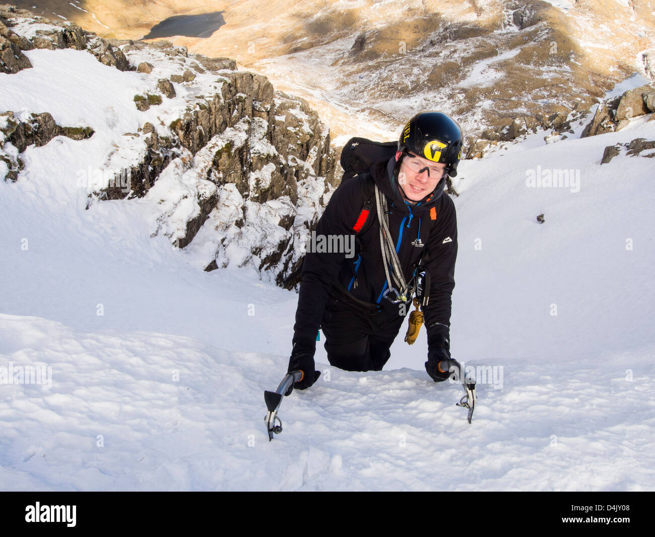Un scalatore nel burrone Custs sul grande fine un grado uno percorso invernale, Lake District, UK. Foto Stock