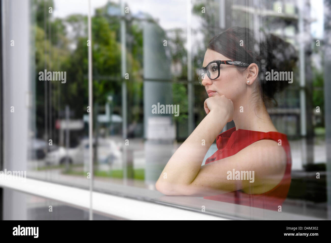 Imprenditrice a guardare fuori dalla finestra Foto Stock