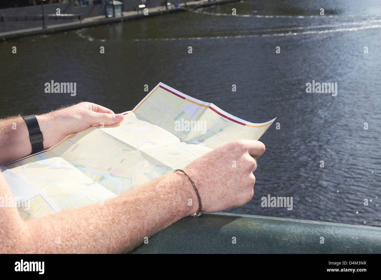 L'uomo la lettura di una mappa della città sul ponte Foto Stock