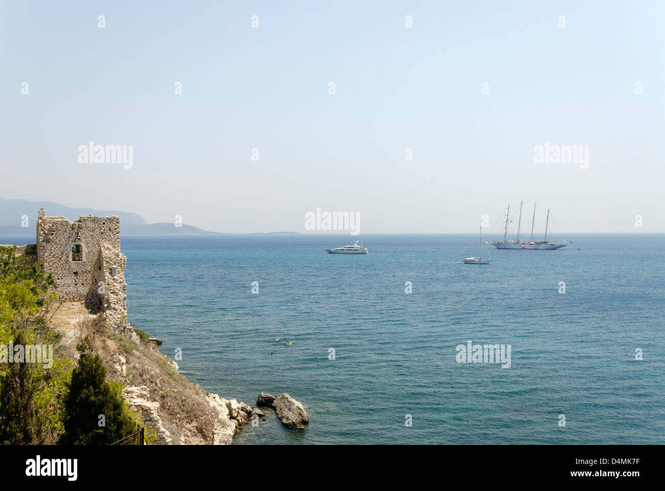 La Grecia. Samos. Barche di navi a vela sul Mar Egeo vicino alle rovine del vecchio castello bizantino nella città di Pythagoreio. Foto Stock