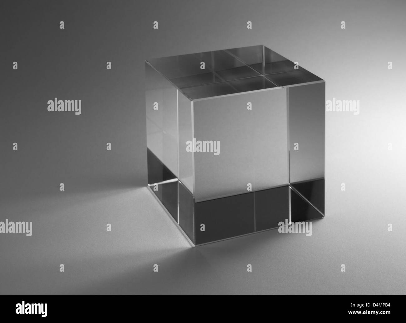 Studio fotografico di un solido cubo di vetro nella parte posteriore grigia Foto Stock