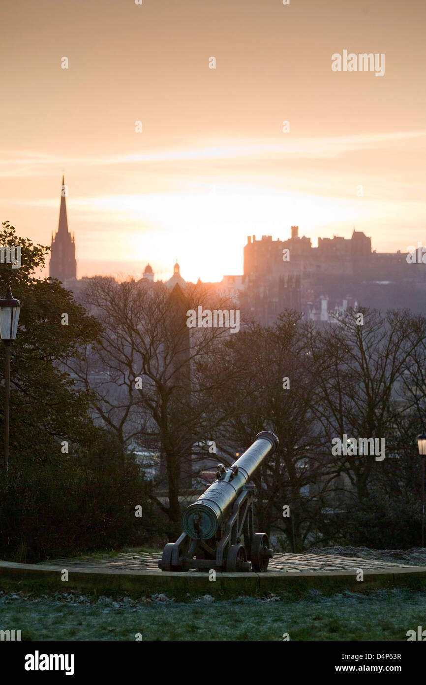 Tramonto dietro al castello da Calton Hill con il cannone Foto Stock