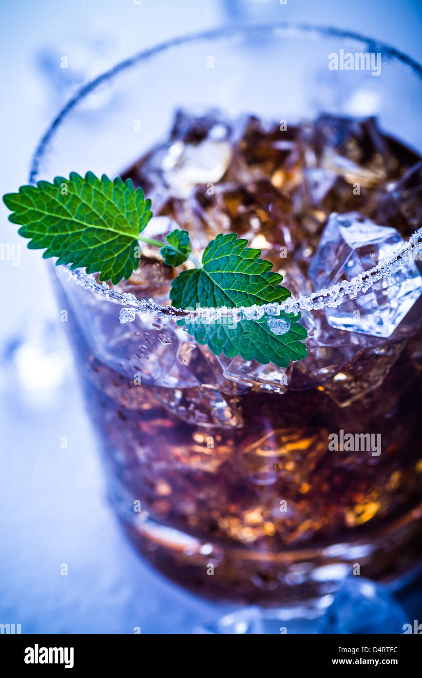 Un bicchiere con un rum, il ghiaccio e la calce e cocktail Foto Stock