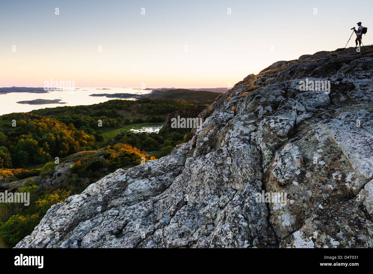 Fotografo su roccia affacciato sul paesaggio, Brattön, Bohuslän, Svezia, Europa Foto Stock