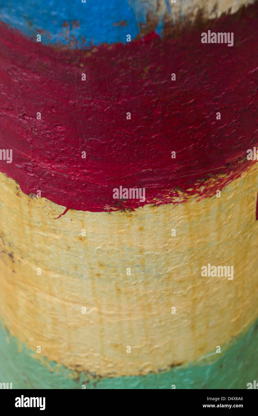 Dipinto artistico urban texture di sfondo con strisce di blu, bianco, rosso, giallo e verde di vernice su una tavola di legno un palo telefonico Foto Stock