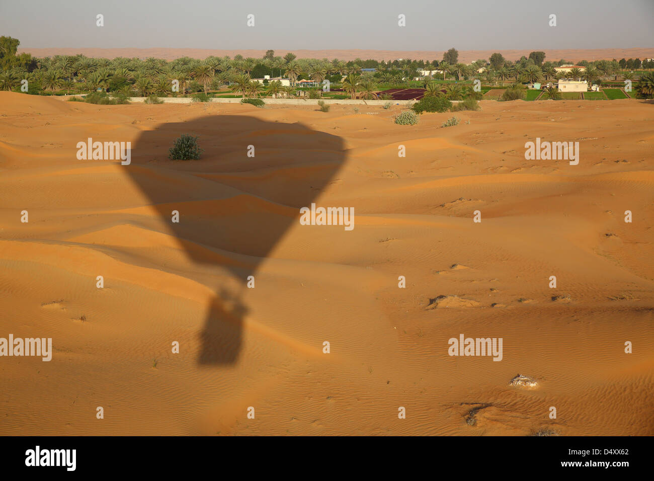 Ombra della mongolfiera oltre il deserto Arabico, Dubai, Emirati Arabi Uniti Foto Stock