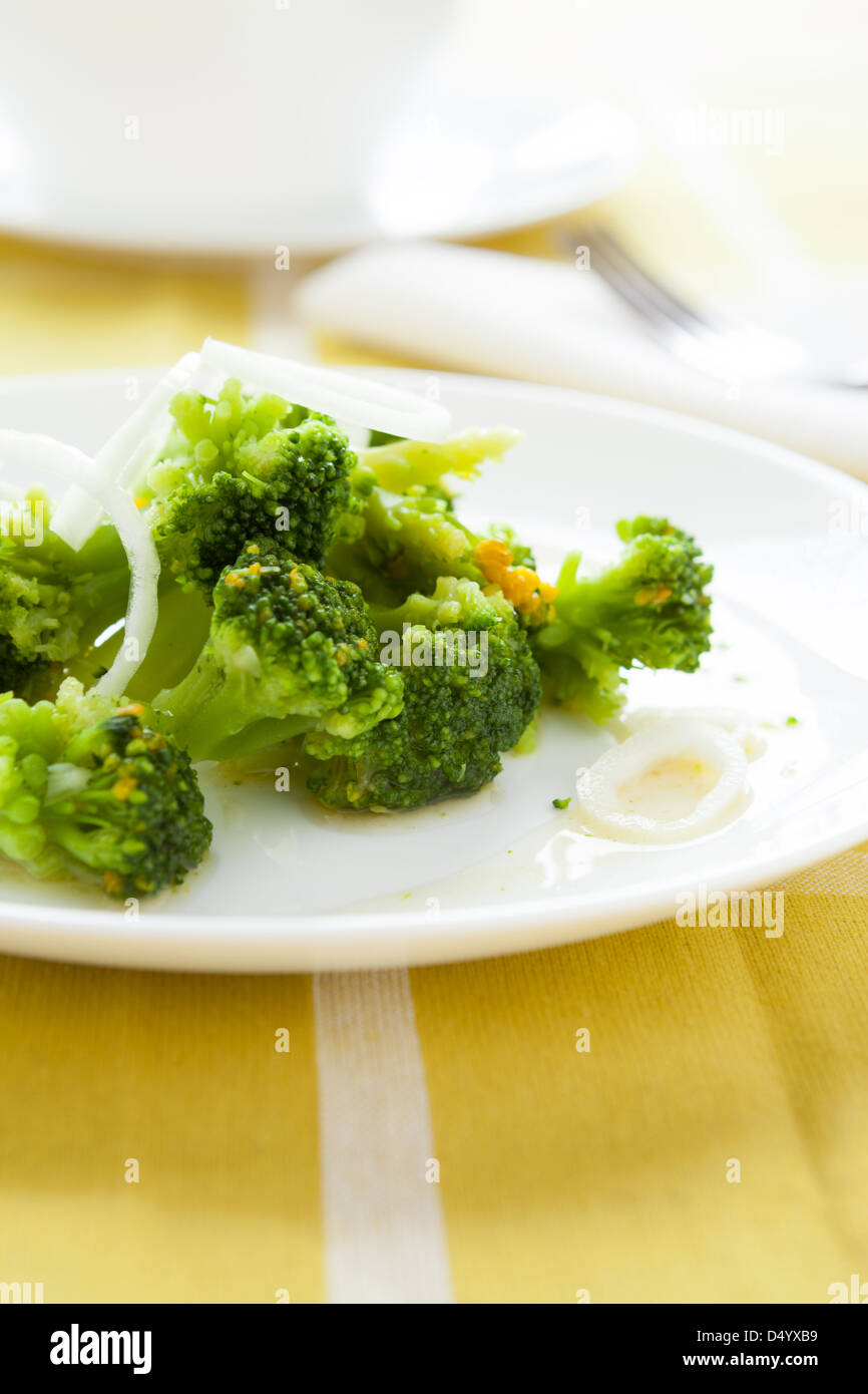 Arrosto di broccoli sulla piastra bianca, primo piano Foto Stock