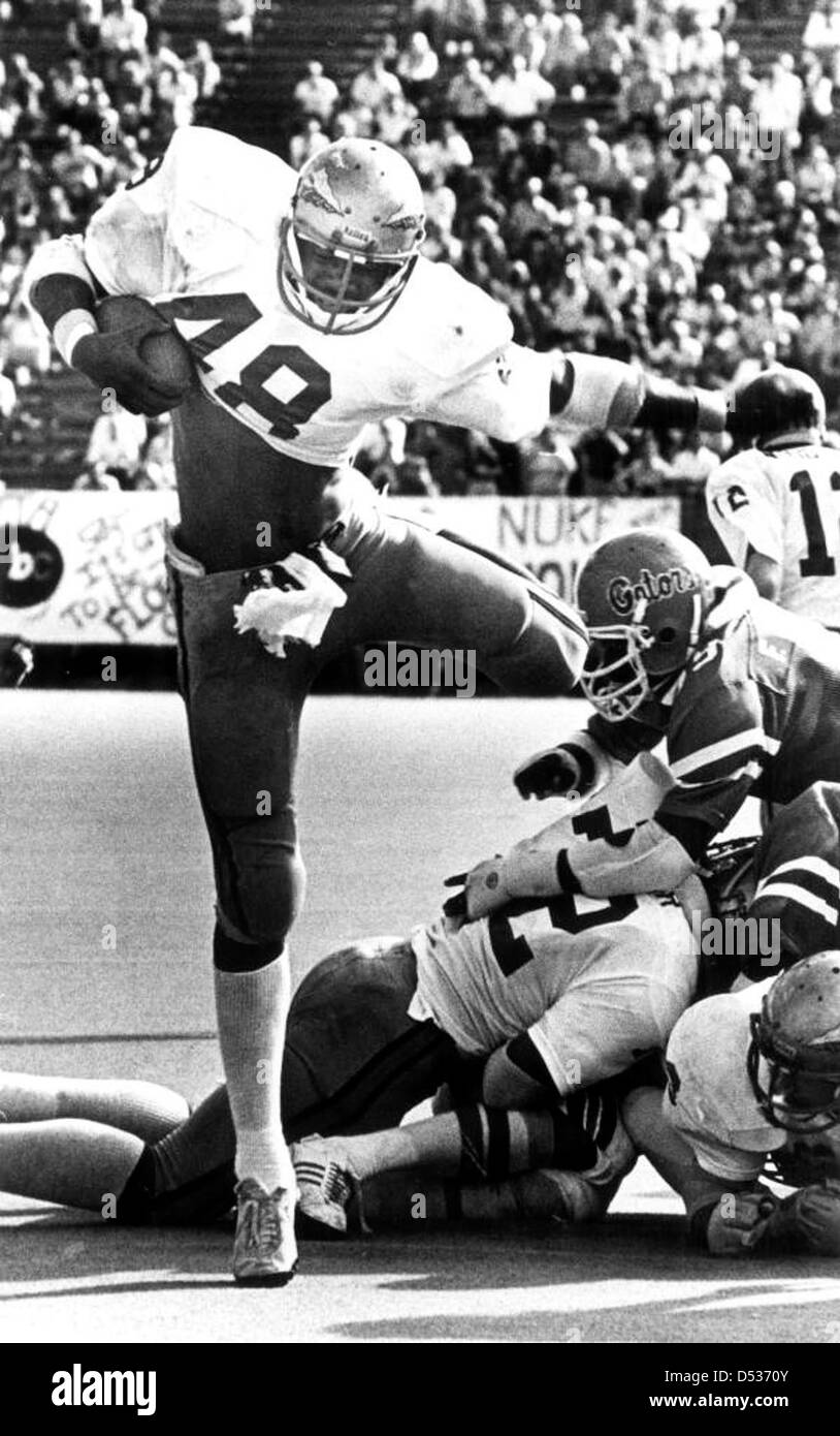 Mark Lyles della Florida State University batte i giocatori della University of Florida durante un'emozionante corsa sul campo. Questa immagine cattura un momento chiave nel football universitario durante una partita di rivalità tra la FSU e l'Università della Florida a Gainesville, Florida. Foto Stock