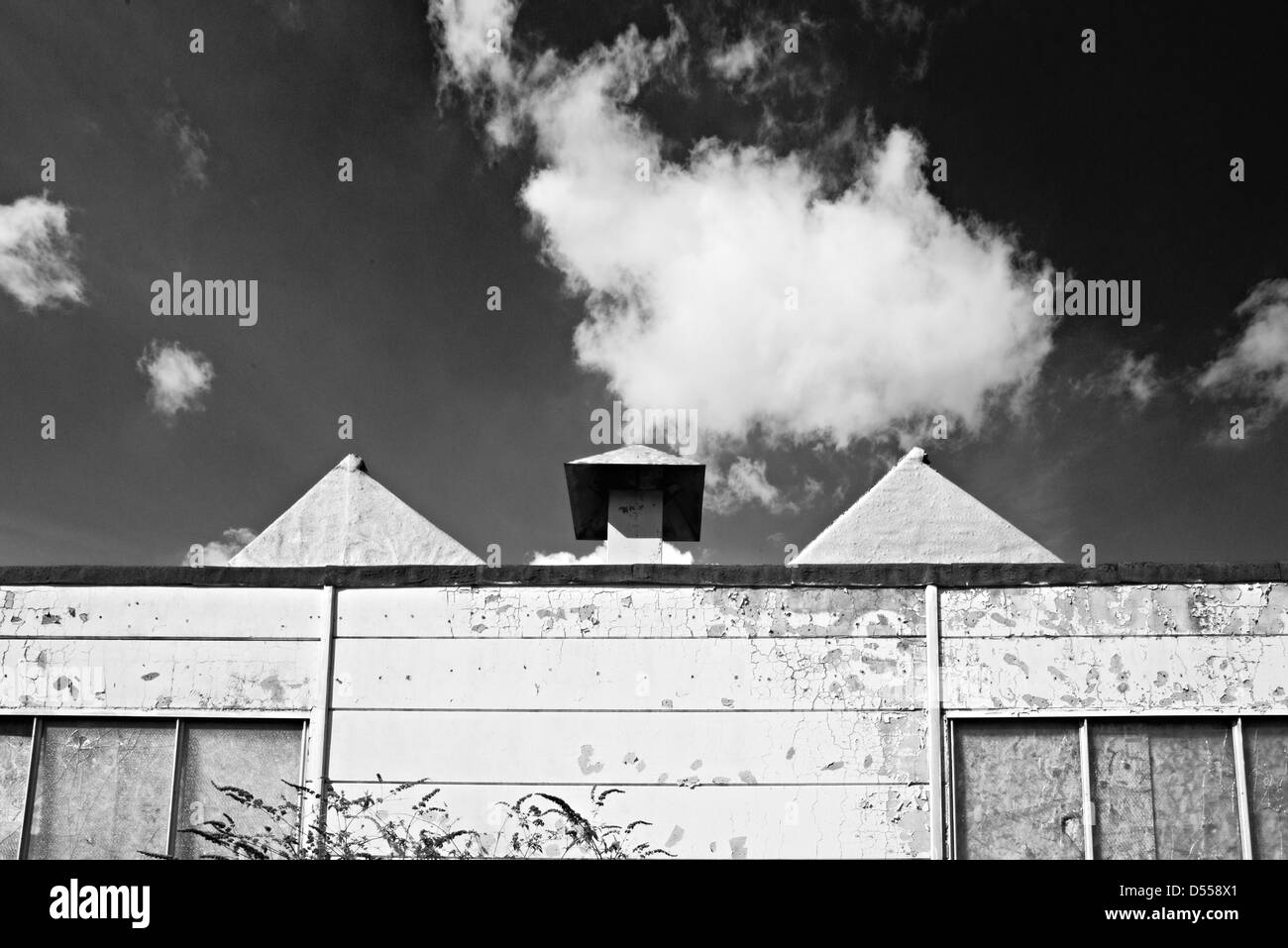 Un abbandonato edificio in fabbrica con il drammatico contrasto la formazione di nube.abbandonati sito industriale Foto Stock