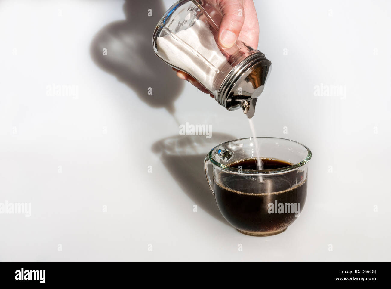 Sole di mattina accende una tazza di caffè e zucchero Foto Stock