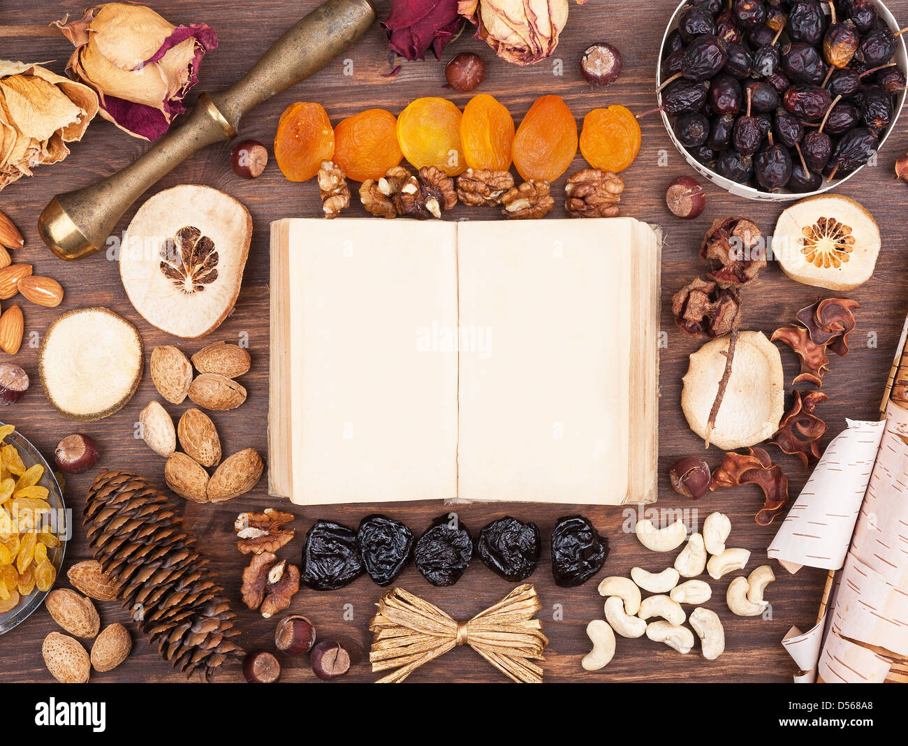 Girare a un vecchio libro in un ambiente di noci e frutta Foto Stock