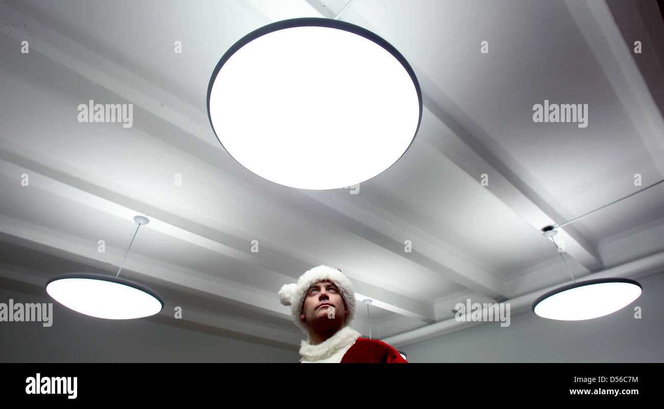 Un uomo mette su una Santa Claus costume in Magdeburg, Germania, 11 novembre 2010. In Sassonia-Anhalt, lavoro agenzie di collocamento inviare 160 'Santa clausole' ogni anno per le feste natalizie e feste private. Foto: Jens Wolf Foto Stock