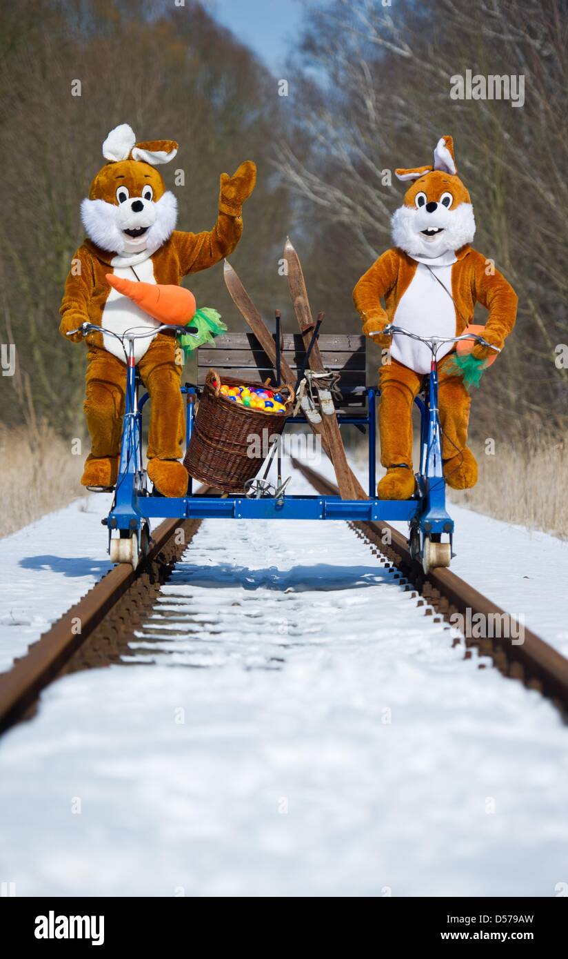 Mellensee, Germania. 26 marzo, 2013. Una illustrazione mostra due persone che indossano Easter Bunny costumi su una rotaia-cycle draisina al chiuso ferroviaria di divertimenti in Mellensee, Germania, 26 marzo 2013. Il coniglietto di Pasqua si nascondono le uova lungo la ex "Royal militare prussiano ferrovia per i turisti di trovare nel quartiere Teltow-Flaeming sulla Pasqua. Foto: PATRICK PLEUL/dpa/Alamy Live News Foto Stock