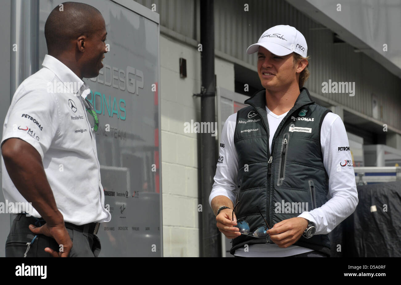 Der deutsche Formel-1-Rennfahrer Nico Rosberg von Mercedes GP unterhŠlt sich am Donnerstag (08.07.2010) im Fahrerlager der Rennstrecke a Silverstone in Inghilterra Mit einem Mechaniker. Am Wochenende avviato mit dem Gro§en Preis von Gro§britannien das zehnte Rennen der Formel-1-Saison 2010. Foto: Carmen Jaspersen dpa Foto Stock