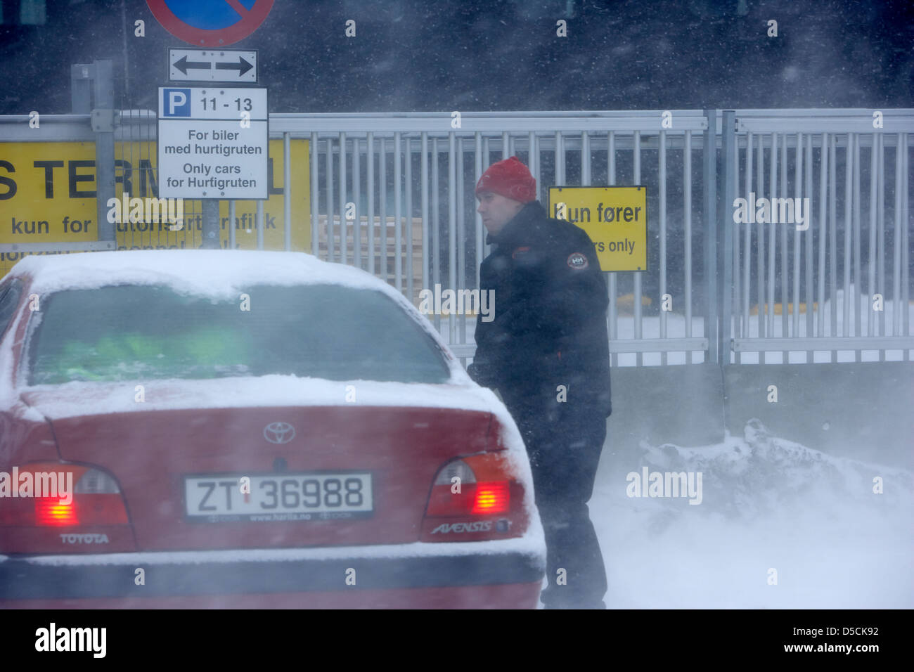 L'uomo sempre nella sua automobile in blizzard coperto di neve durante l'inverno hammerfest finnmark Norvegia europa Foto Stock