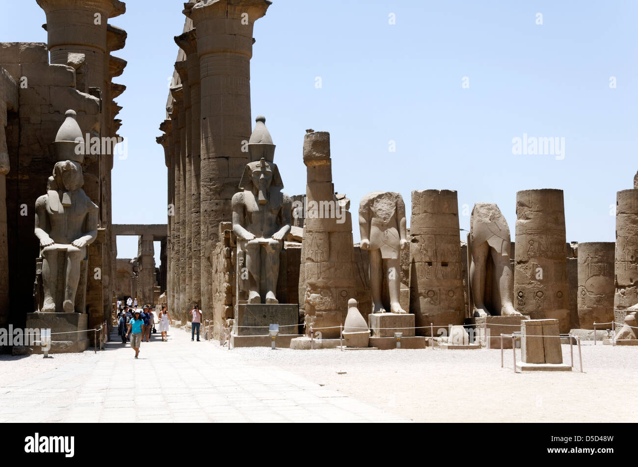 L'Egitto. Tempio di Luxor corte di Ramses. Colossali statue di Ramses II all'ingresso del Grande Colonnato di Amenofi III. Foto Stock