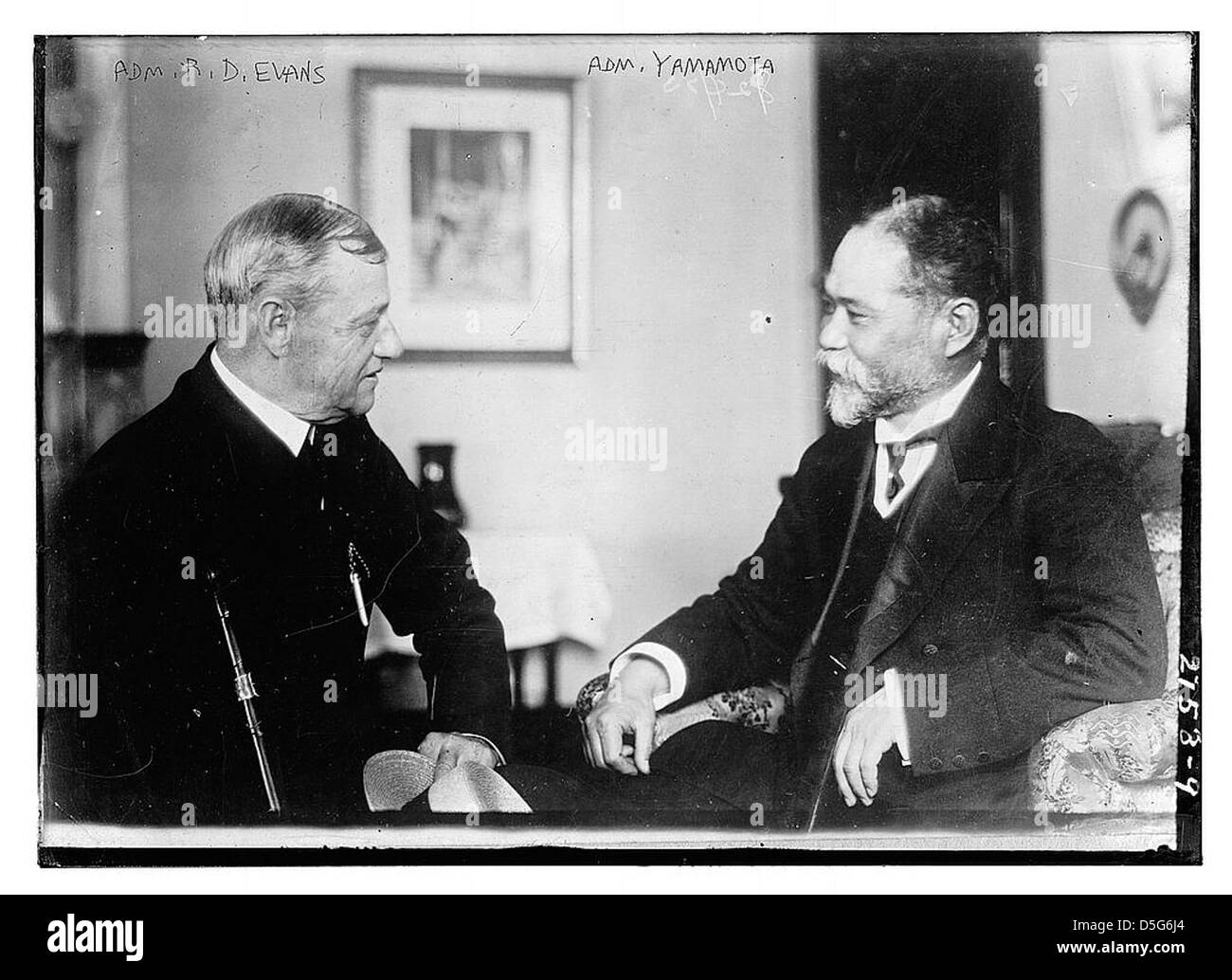 Gli ammiragli R.D. Evans e Yamamoto sono visti seduti insieme. L'immagine evidenzia i loro ruoli di spicco nella leadership militare, con un focus sulle figure contrastanti delle forze navali americane e giapponesi durante la seconda guerra mondiale Foto Stock