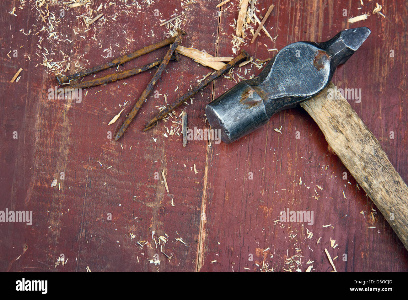 Vecchio rustico martello sul vecchio rosso sfondo di legno - concetto DIY Foto Stock