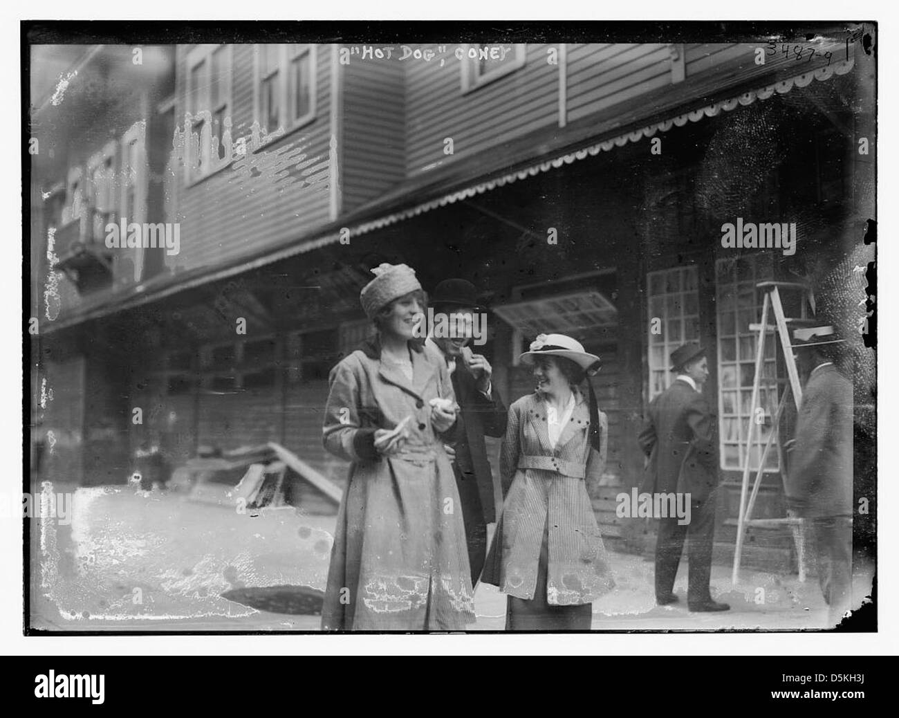 Questa immagine della Biblioteca del Congresso mostra un venditore di hot dog a Coney Island, New York, nel 1915. La scena cattura un momento classico della cultura americana, con i famosi hot dog di Nathan serviti presso l'iconico lungomare di Coney Island. Foto Stock