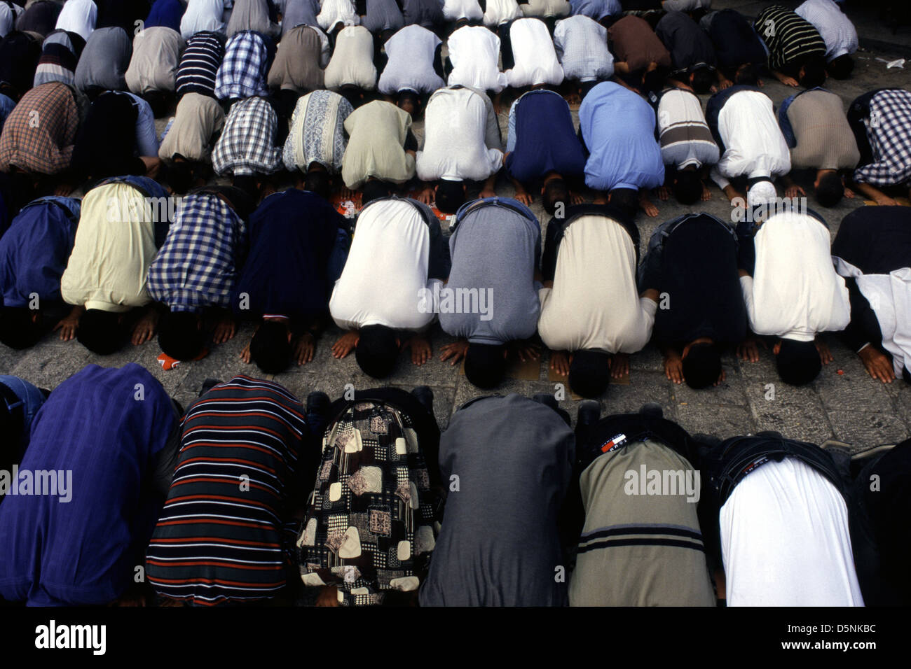 Gli uomini palestinesi si prostrano durante la preghiera di Salah nella Città Vecchia di Gerusalemme Israele Foto Stock