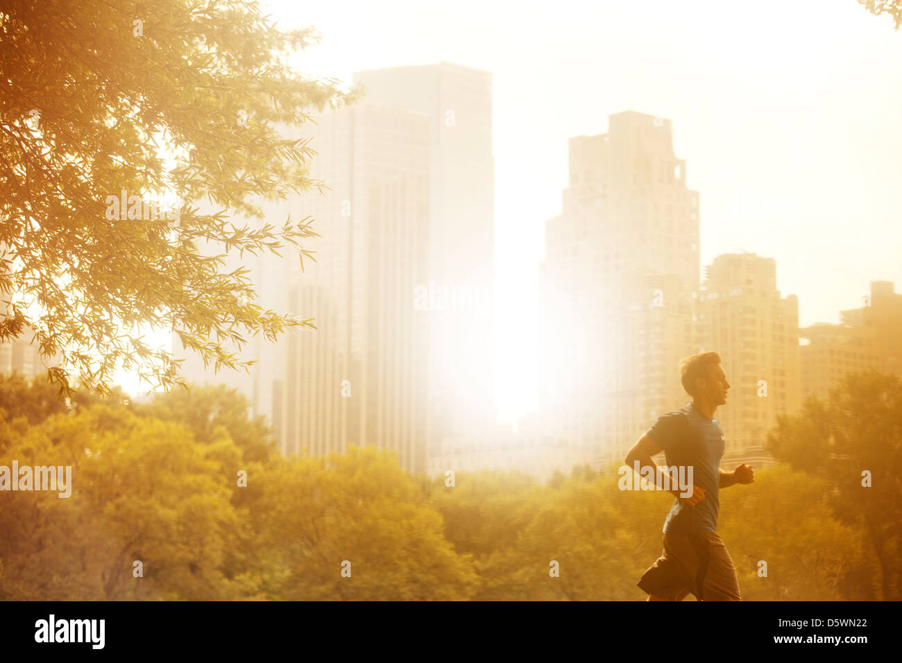 Uomo che corre nel parco urbano Foto Stock